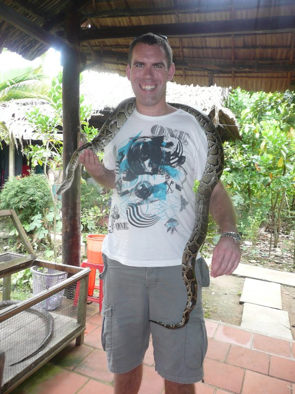 Paul holding a python snake 
