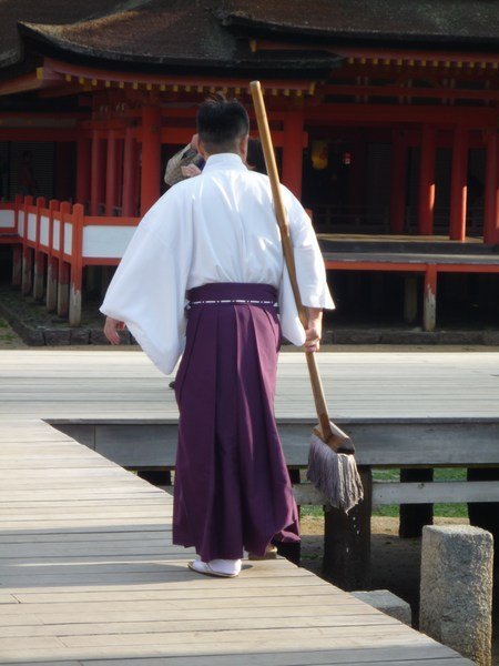 Priest going to clean the inside of the shrine