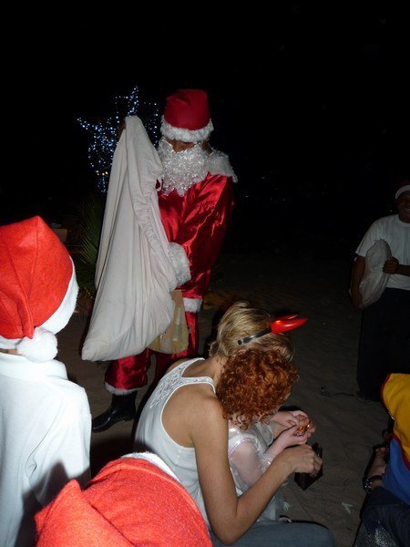 Santa giving presents to the kids