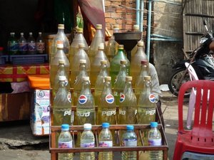 Petrol (gas) for motorbikes sold at the roadside in Pepsi bottles