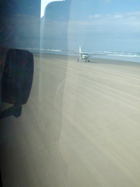 Plane landing on 75 Mile Beach