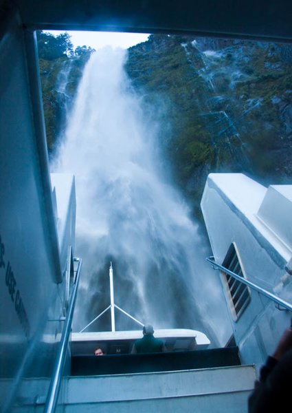 Milford Sound - waterfall towering over our little boat
