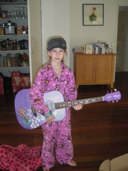 Eva with guitar just like Hannah Montana's