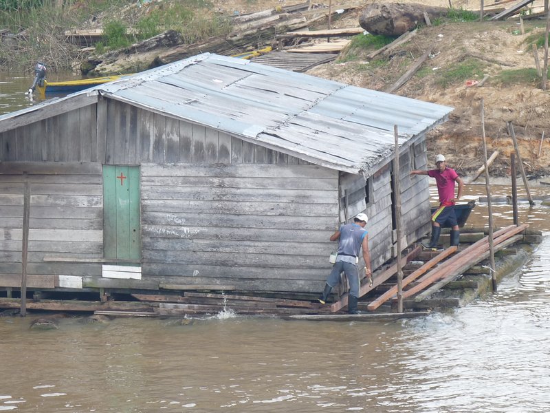Villagers building a floating house