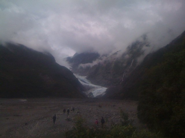 A stunning sight...people trekking across the old bed of the glacier to its terminal face