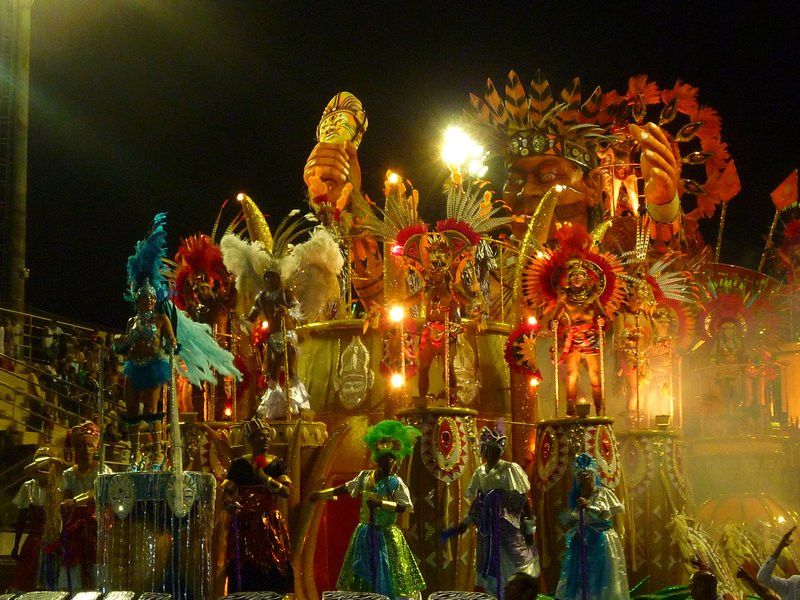 A monster of a float wobbling with dancers