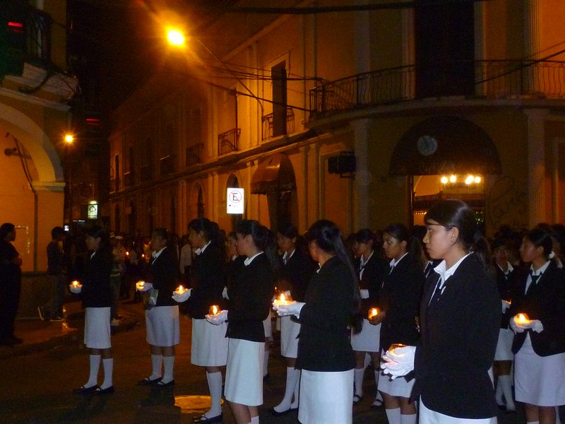 School children follow the parade candles in hand