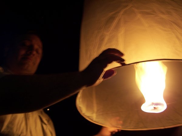 Rick holding lantern until fills with hot air
