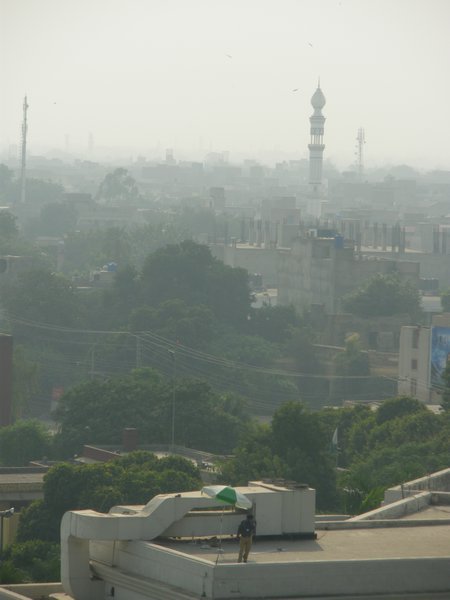 Policeman on rooftop with Minaret in the distance