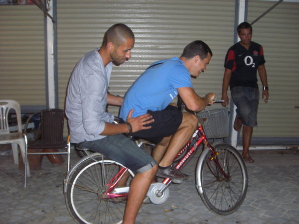 Dan on a taxi bike, getting a lift from one of the locals... hold on, that's not a local.