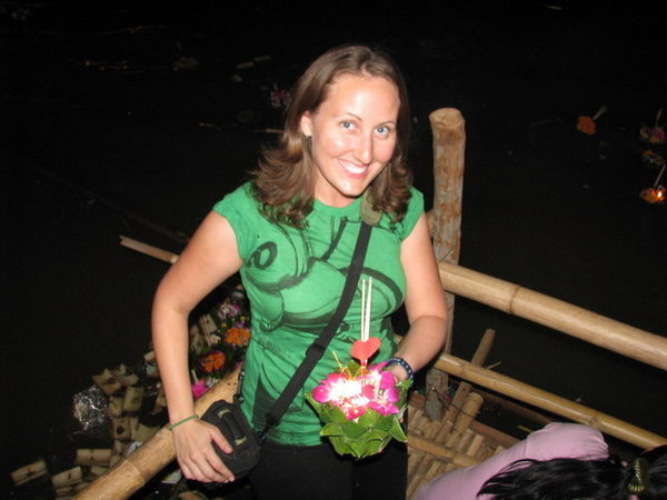 holding a krathong at the river