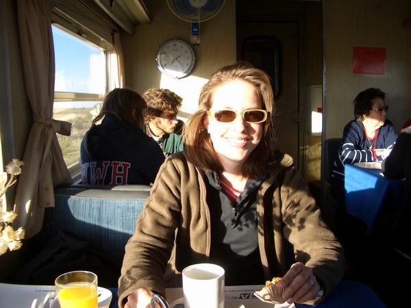 Melia enjoying breakfast on the train after sleeping all night