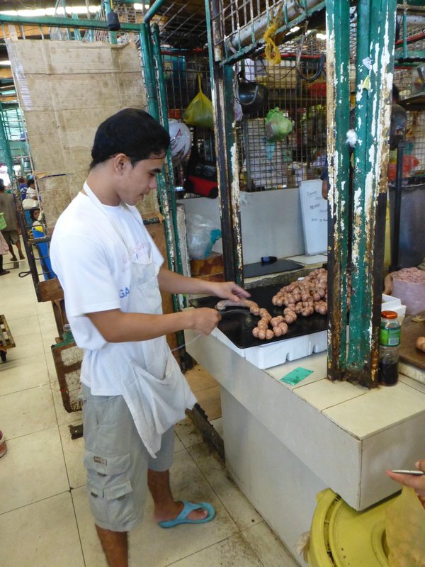 Preparing sausages at the city market