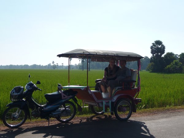 Our tuk-tuk, rice paddies behind