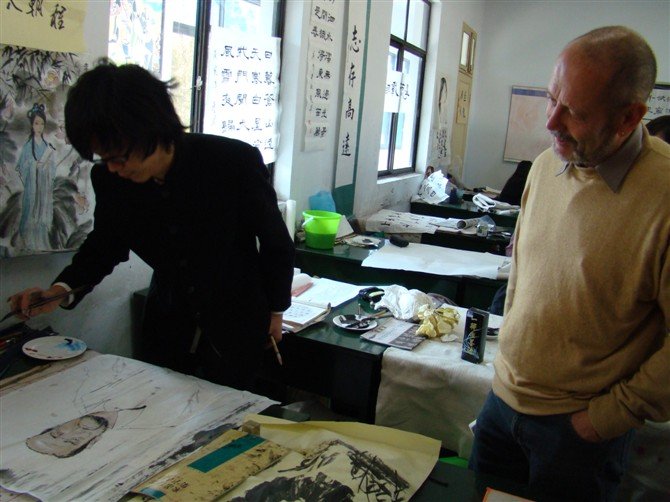 He is drawing Chinese painting for the german school head!
