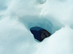 Crawling through a small ice cave