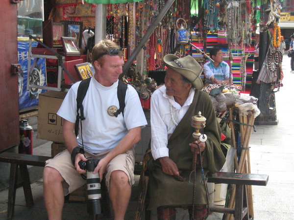 Nigel sits with a local in Lhasa