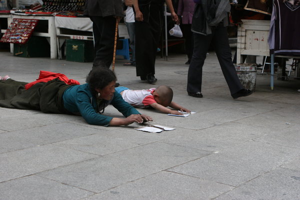 A woman and her son prostrating