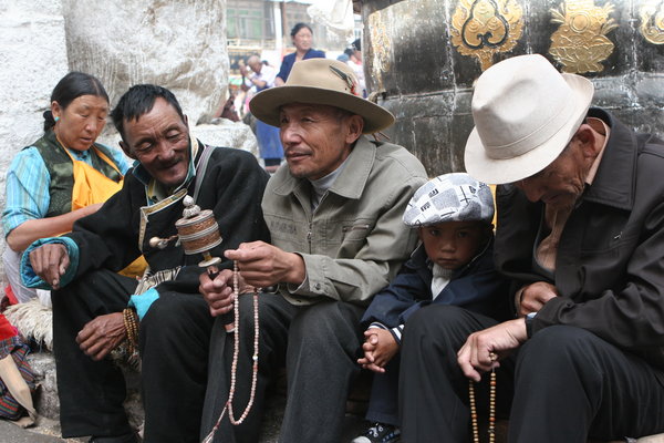 Pilgrams sitting outside Jokhang Temple