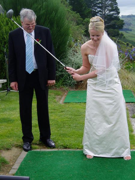 The bride tries her hand at golf