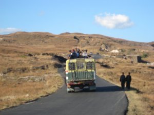 Local bus with rooftop passengers