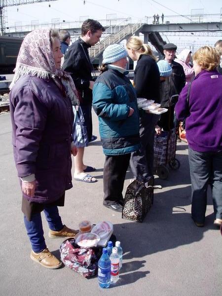 Babushkas selling food at a lonely station