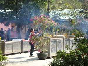 lighting incense at the temple