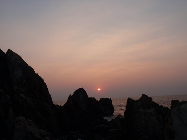 sunset over rocky headlands