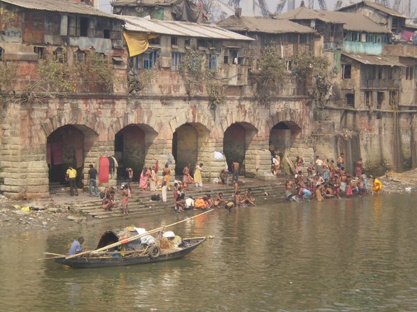 River bank dwellings and bathers