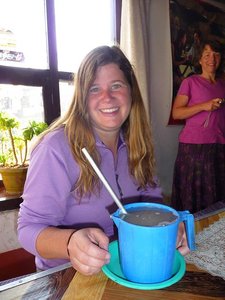 Rachel trying tongba (millet beer with hot water)