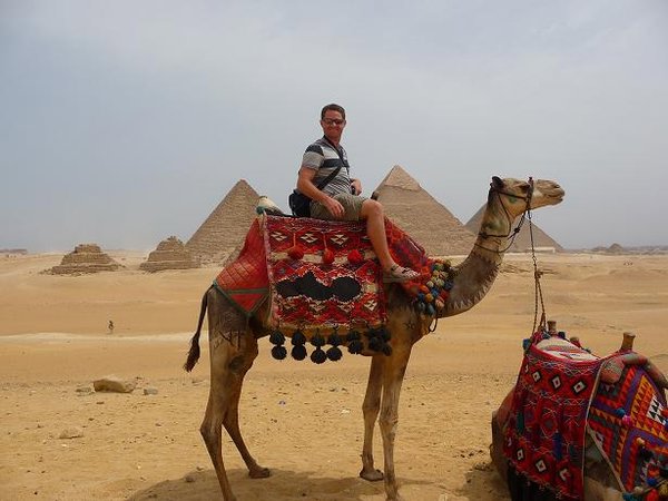 Ian riding a camel around the Pyramids