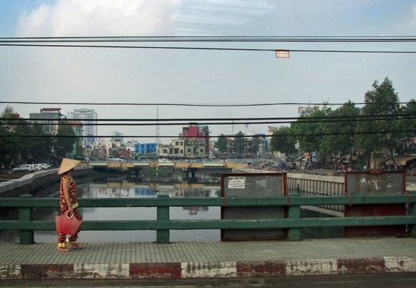 Lady on bridge in Saigon