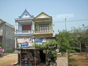 Somewhat typical housing seen in Vietnam (with "huts" being most typical)
