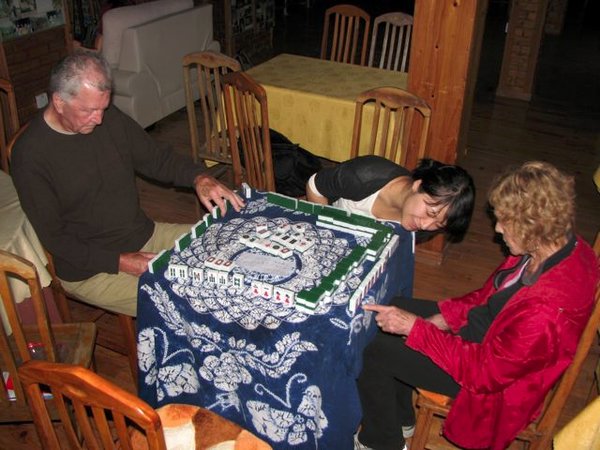 Ling teaching us Mahjong- and peaking at Judy's pieces.