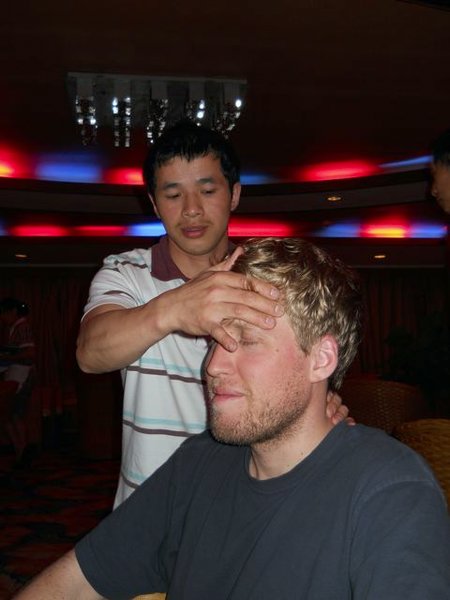 Damon getting a neck massage- and possibly having his temperature taken.