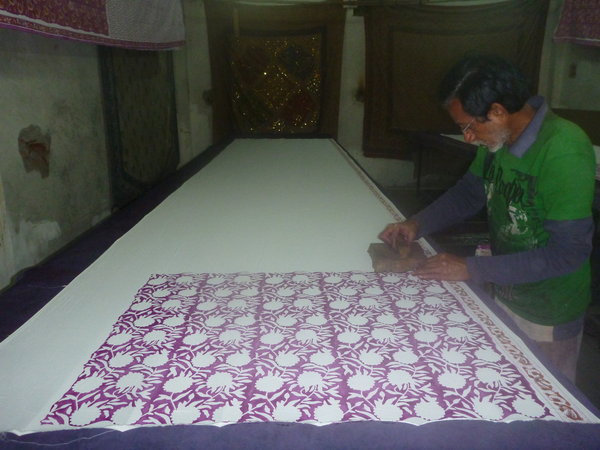 man hand-stamping fabric