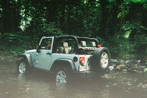 Rustin and our Jeep crossing a river!