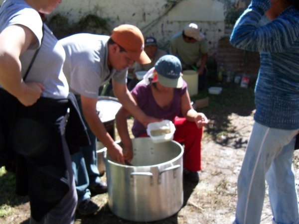 Soup Containers Being Filled from Large Pot