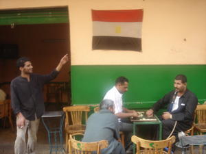 Egyptian flag flies above a game of Dominoes