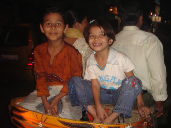 kids ride on the back of a rickshaw