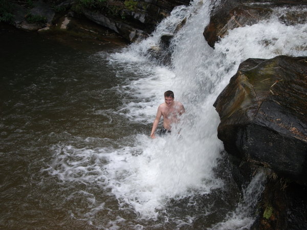 James taking a shower at the Waterfall camp