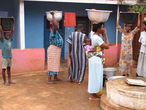 Women from the village fetching water from our well