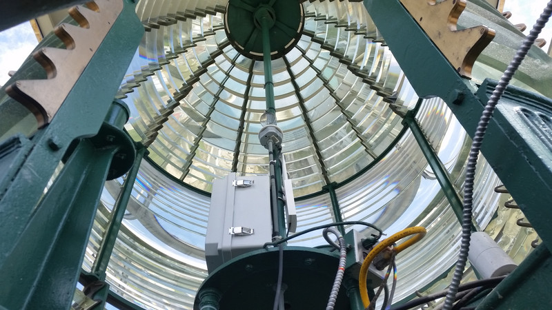 A Look Inside the Fresnel Lens:  That Little Lightbulb (Dead Center) Can Be Seen for 22 ½ Statute Miles – Such Is the Power of the Prism