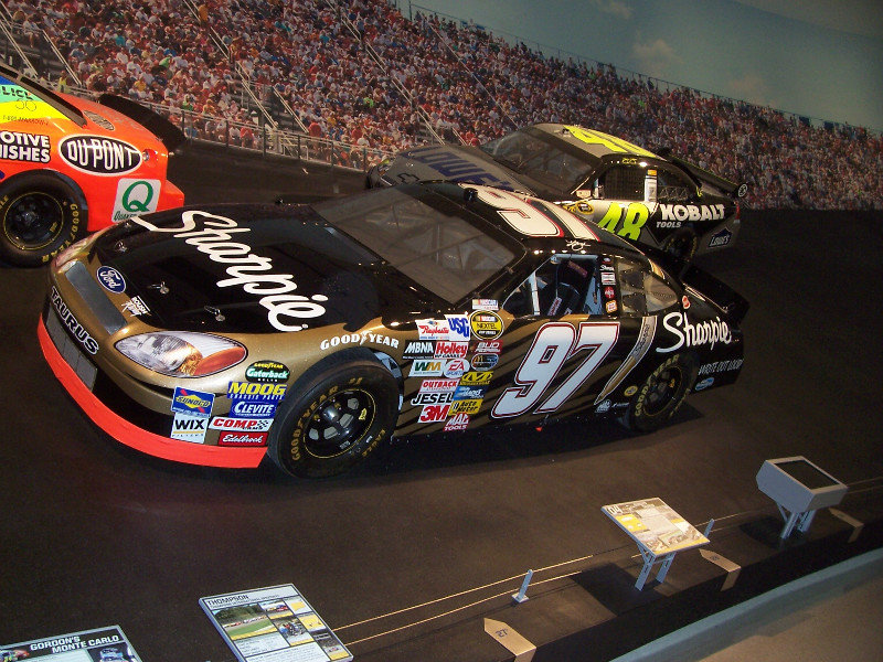 Kurt Bush’s 2004 Ford Taurus With Jimmie Johnson’s 2008 Chevrolet Impala SS In The Background