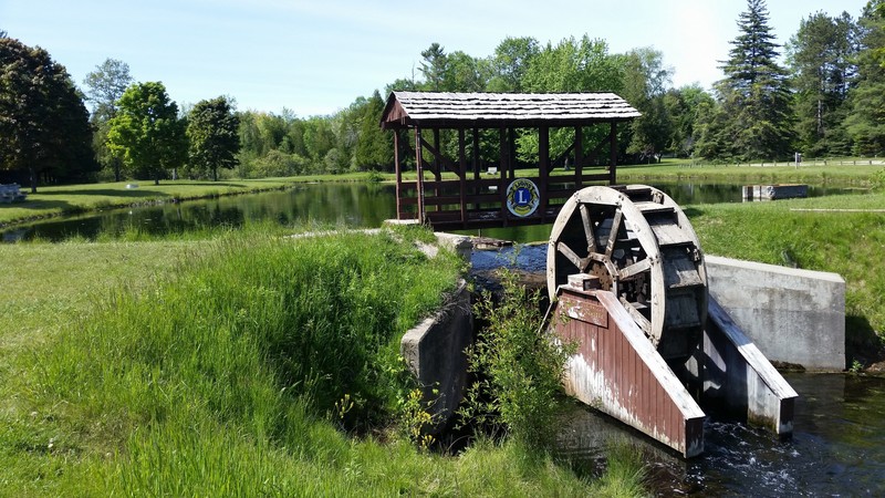 The Covered Bridge And Water Wheel Add Personality To The Park
