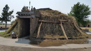 A Replica Of An Earth-Covered Lodge
