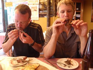 Chuck and Morgan are brave enough to try guinea pig in Aguas Calientes