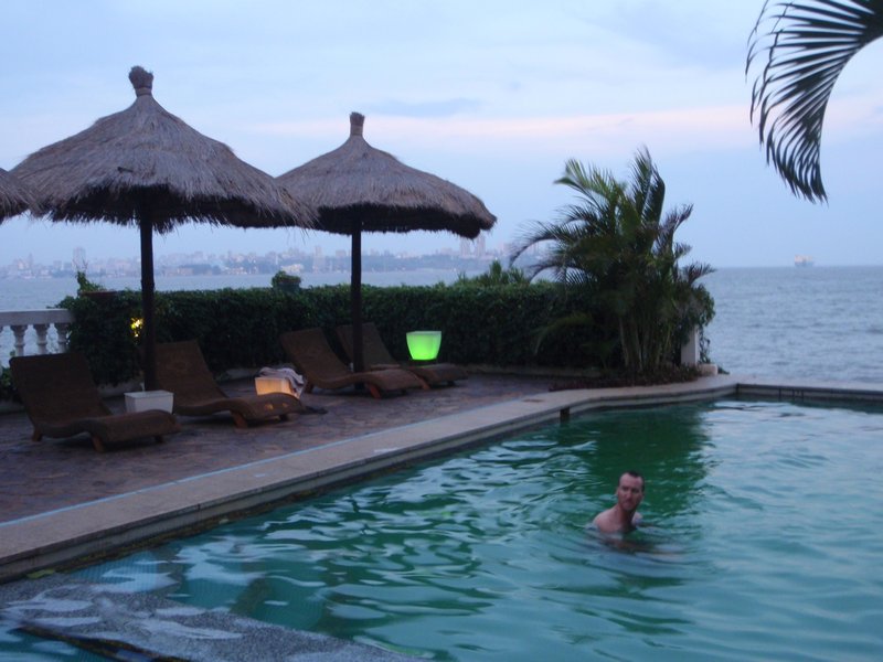 Chuck trying to refresh himself in the murky swimming pool at the Gallery Hotel, Catembe