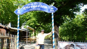 Tourist posing with his bag of Andechs souvenirs