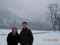 Tyler and Cassie battle the snow to stand below Neuschwanstein Castle
